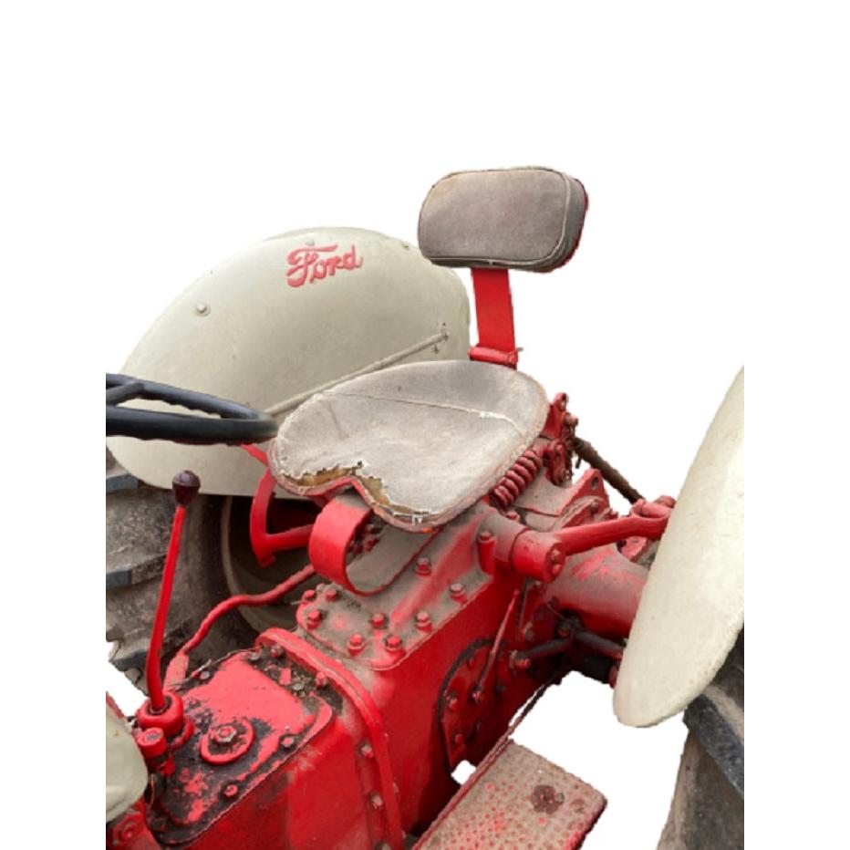 Red steel pan tractor seat with foam cushion and 4-bolt mounting pattern for International Harvester and Ford tractors.