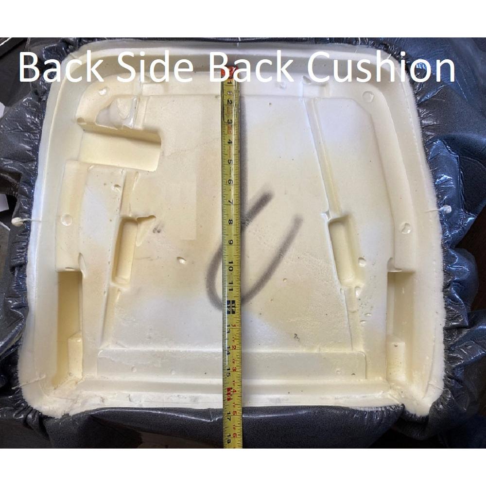 Gray fabric Sears tractor seat back cushion with exposed foam backing and measuring tape for scale.